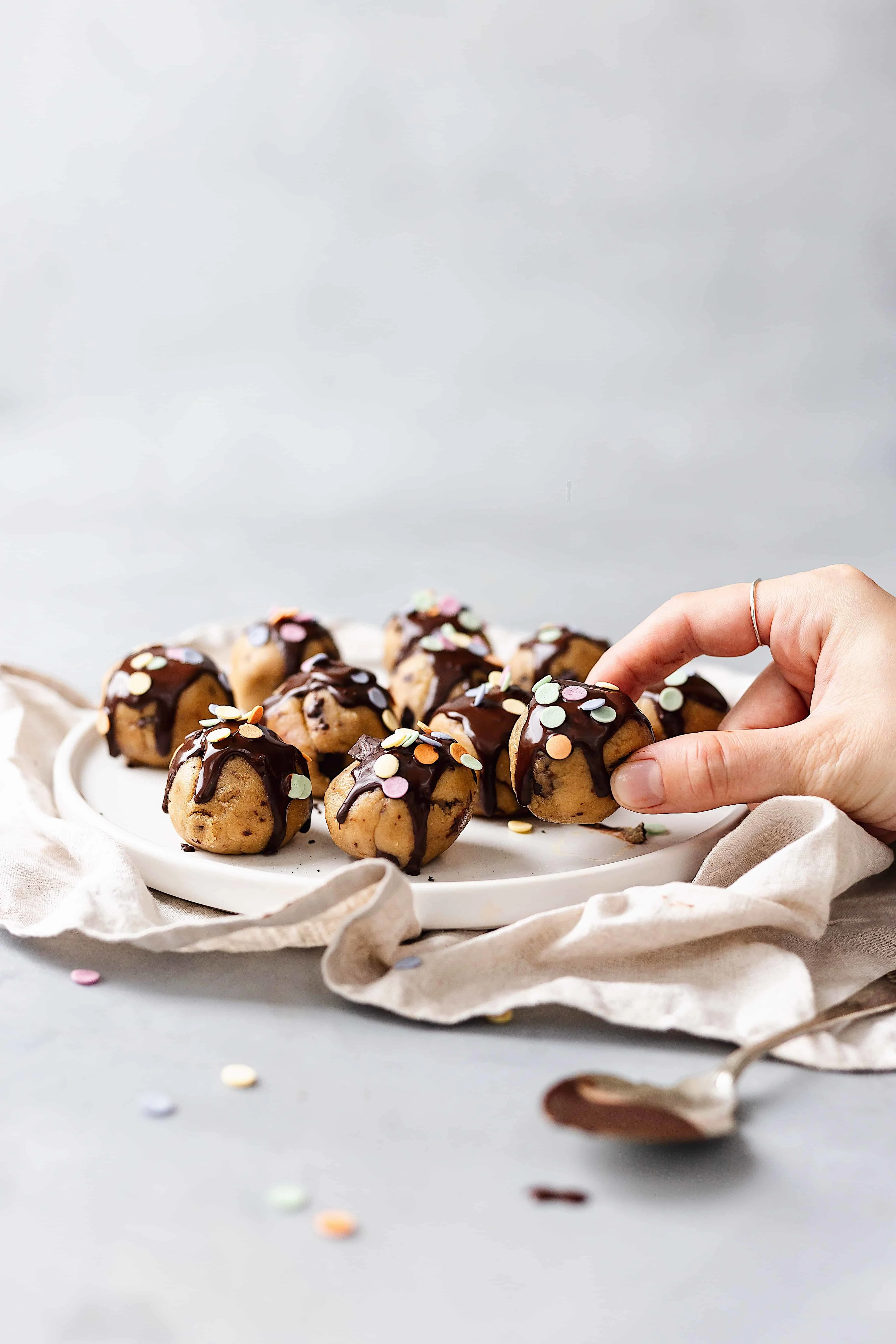 vegan cookie dough bites hand grab